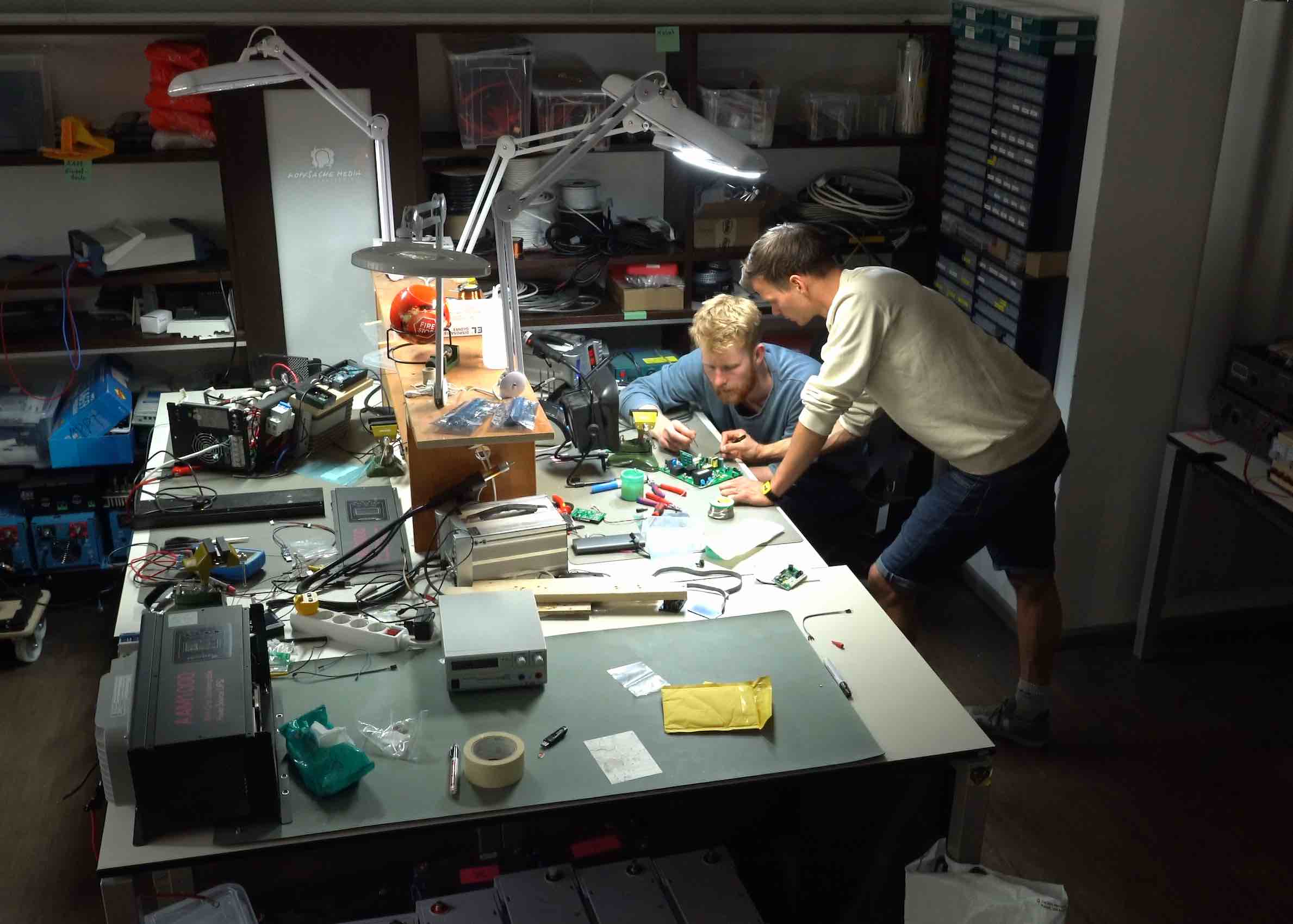 Two engineers are working on solar boards in an office