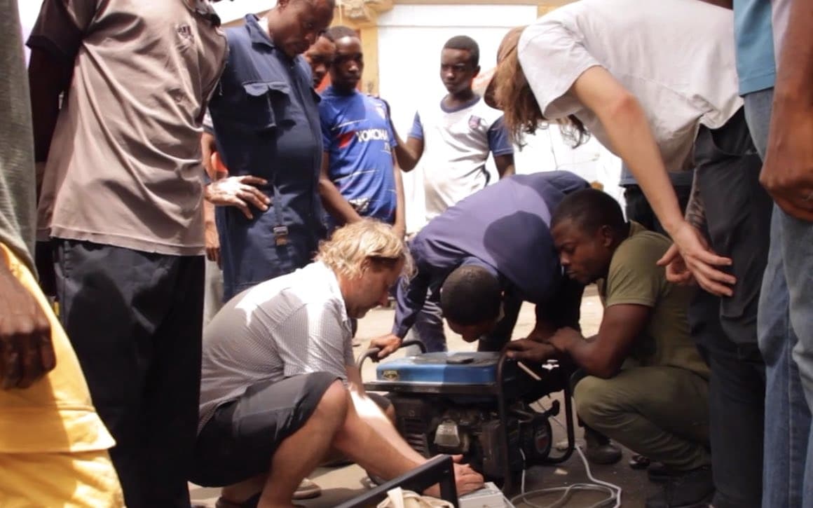 A group of men work on a fossil fuel generator